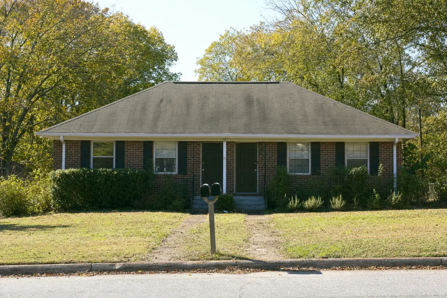 Brick rental house on a quiet Georgia street with mailboxes out front